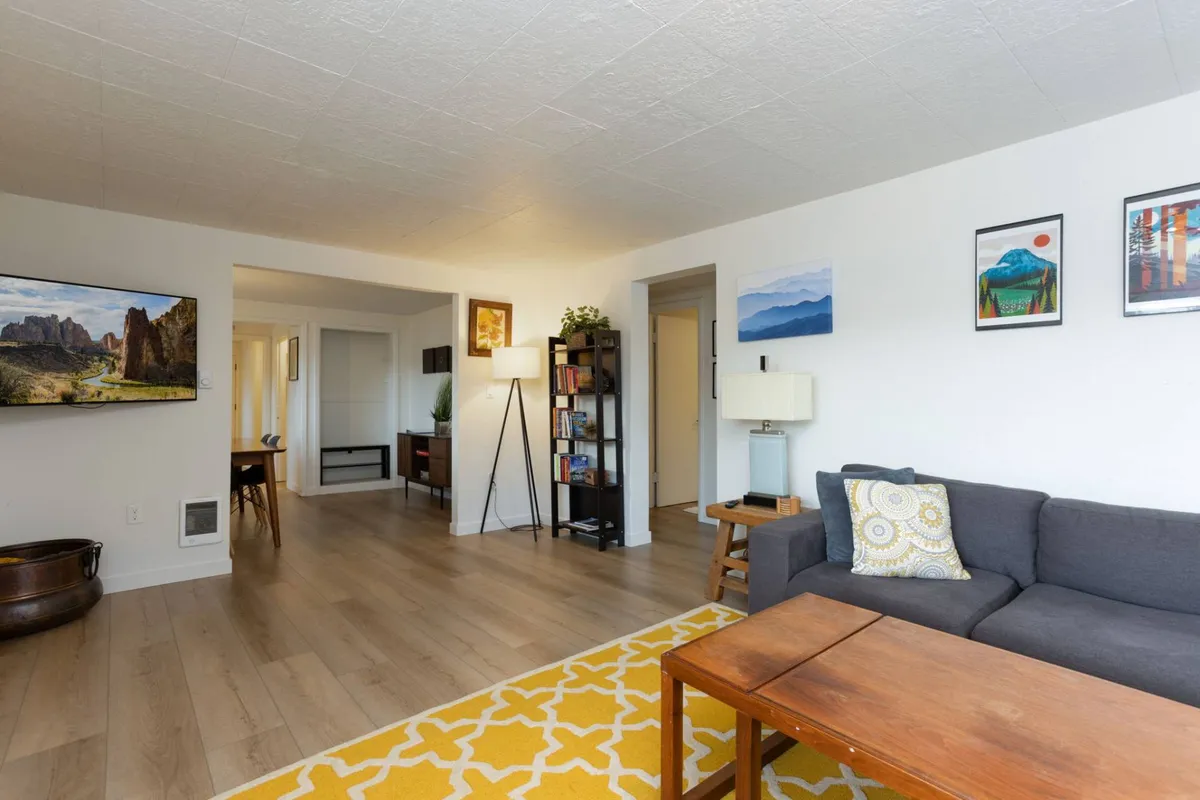 A cozy living room with a comfortable sofa, coffee table, and inviting decor, suggesting a welcoming space to relax after a day of exploring outdoors with a pet.